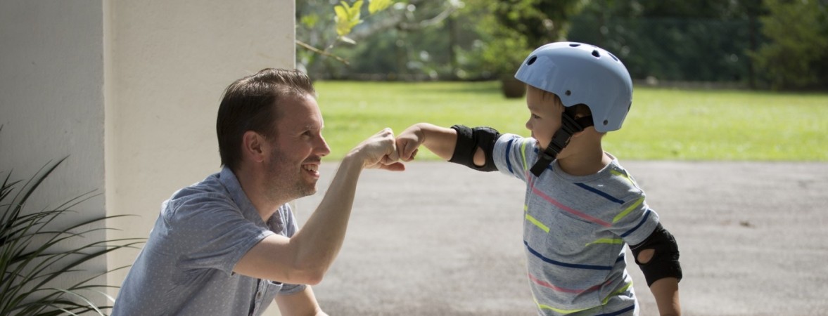 Father and son bumping fists